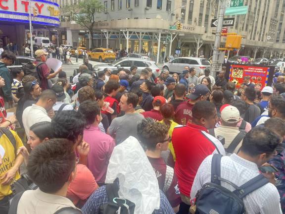 A crowd of Arsenal fans gathered at the corner of 50th and 6th avenue to witness the street reveal. (Photo: Jacqueline Gordon)