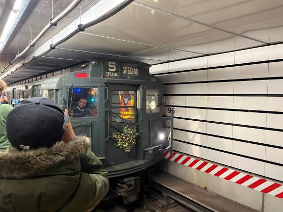 No matter where the Holiday Nostalgia Train travels, the paparazzi are everywhere. Here at the East 96th Street - Second Avenue station, the northern end of the Q line, the train’s motorman looks amused at all the photographers taking his picture.
