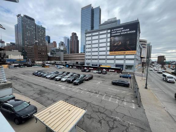 A view from the pedestrian Twelfth Avenue Bridge at 46th Street looks south, over the 50,000-plus square-foot space that will be a mixed-use building covering the entire space, but will include Intrepid Museum parking.