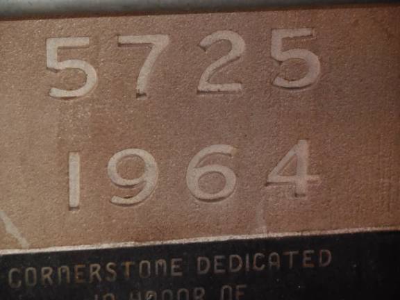 The cornerstone to the former Fur Center Synagogue on West 29th Street, showing the year according to both Jewish and Western calendars. Photo by Raanan Geberer