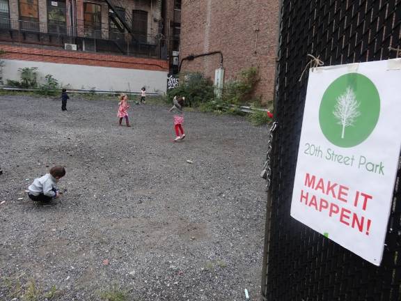 Children play in the vacant lot at 136 West 20th Street that community activists are seeking to turn into a park. Photo by NYC Park Advocates