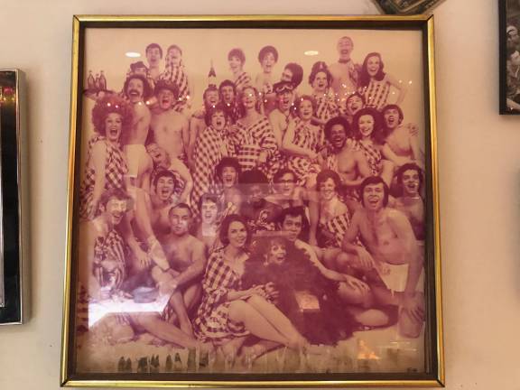 From Horne’s wall of fame, a framed photo of the cast of the Broadway production of <i>Applause</i>, starring Lauren Bacall (center, second row from top).