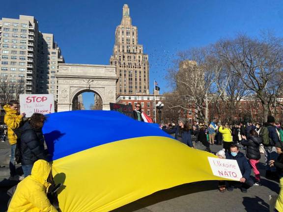 Ukrainian flag held in front of Washington Square Arch during February 27 rally.