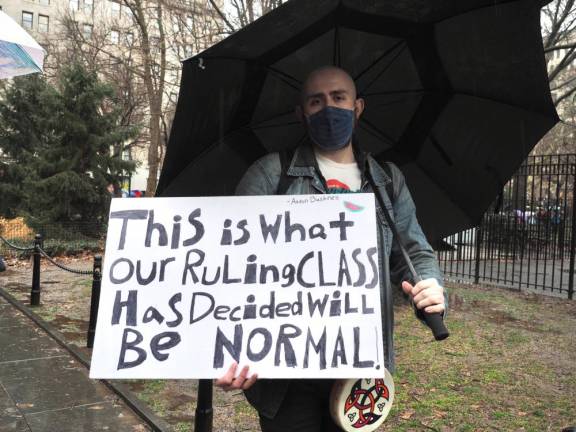 A demonstrator holds a sign with a quote from Aaron Bushnell, a 25-year-old U.S. Air Force service member who self-immolated in front of the Israeli Embassy in Washington on Feb. 25 in protest of Israel’s actions in Gaza, which he called a genocide.