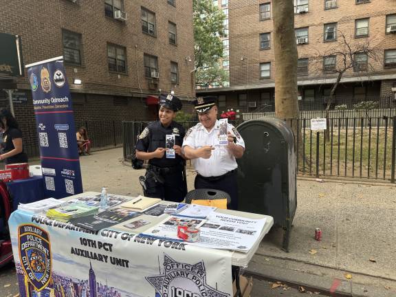 Analiz Cruz, an Auxiliary Police Officer, with another NYPD officer proudly running their booth at Precinct 10’s National Night Out in Chelsea.