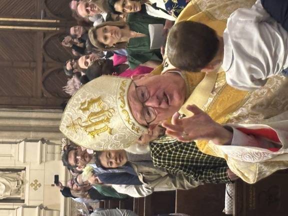Cardinal Timothy Dolan blesses a small child at the annual Easter Sunday Mass at St. Patrick’s Cathedral.