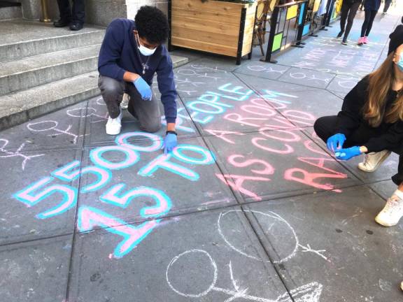 Upper West Side Open Hearts Initiative rallied outside the Lucerne on Sunday, Nov. 29, demanding that the city halt the move. Advocates drew stick figures to represent the 5,500 New Yorkers still in congregate shelters. Photo: Upper West Side Open Hearts