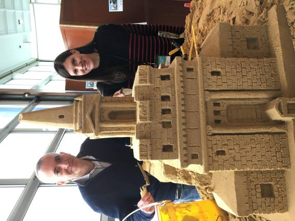 Children's Museum of Manhattan Board Co-Chairs Shannon Bauer Aronson and Matt Messinger admire a sand model of the museum's new building at 361 Central Park West. Photo: halley k harrisburg