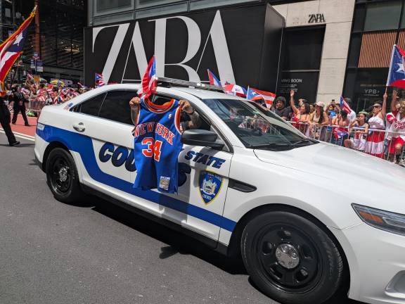 Puerto Rican Day parade included a Court officer holding a No. 34 Charles Oakley Knicks jersey.