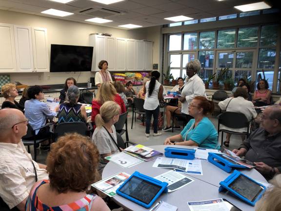 CB8 Census Committee Chair Loraine Brown (standing, right) and U.S. Census Bureau representative Joli Golden (standing, left) lead at a 2020 Census job opportunities workshop held at Lenox Hill Senior Center earlier this summer.