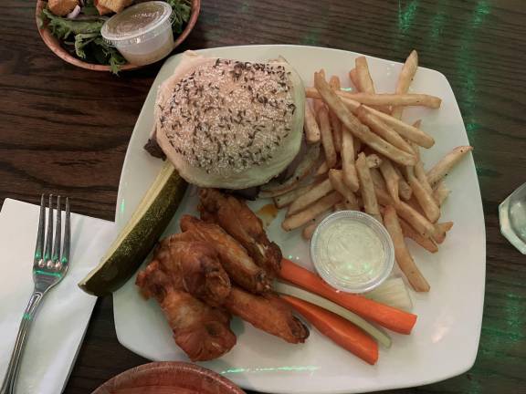 Hungry? At Cole’s, a longtime Buffalo fixture, a beef on weck (roast beef on a kimmelweck roll) is combined on a plate with wings, two staples in this town! The carrots, celery, and blue cheese dressing are a must!