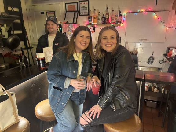 Sarah Kate Thomas (left) dines with friend Meghan Grabowski at Wayne &amp; Sons in the East Village while co-owner Justin Seitzler works the counter. Thomas, who hails from Texas, said she’d be “devastated” if her favorite taco place is forced to close.