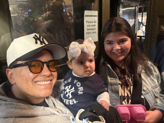 A mom named Michelle (right) accompanied by her daughter Lulu and her husband were among the fans who climbed on board the Yankee Express nostalgia train. “It’s amazing,” she said of the special train.