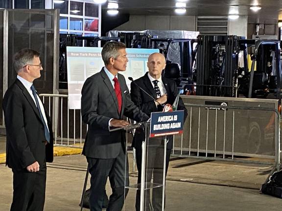 Transportation Secretary Sean Duffy (at mic) says the Trump administration wants to get shovels in the ground on the Penn Station rebuilding effort by the end of 2027, before Donald Trump leaves office. He is flanked by Deputy Transportation Secretary Steven Bradbury (left) and Andy Byford, the Amtrak executive who was appointed to oversee the rebuild.