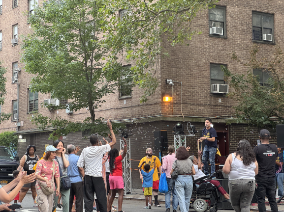 The DJ gets community members up and dancing on West 17th Street, celebrating the community as well as the NYPD.