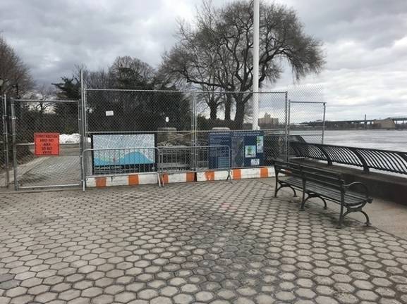 A stretch of the East River Esplanade behind Gracie Mansion is cordoned off after last year’s collapse of a chunk of the seawall along the waterfront pathway near 88th Street. Photo: Douglas Feiden