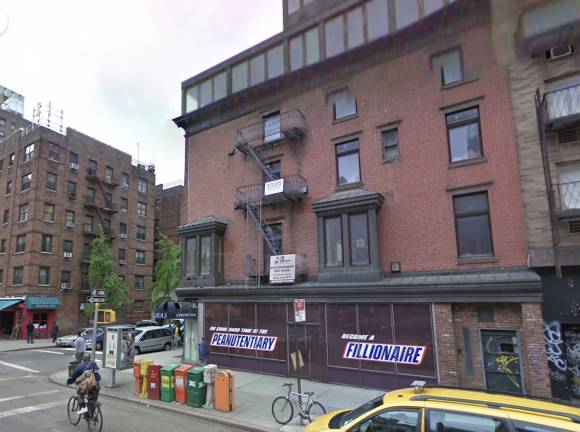 210 Seventh Avenue as seen in 2009, note Chelsea’s Espresso Bar and many street newspaper boxes.