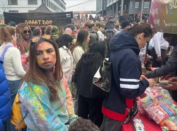 This young mom has a youngster in tow as she makes her way toward the vendors.