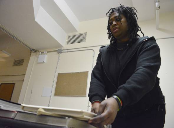 Marcie Chase, who served time at the former Bayview Correctional Facility, organized the reading room table of the Annie Leibovitz portrait exhibition held there. Chase's favorite set of pictures featured photos of drag queens ready to perform, juxtaposed with their less painted daytime looks. Photo: Diamond Naga Siu