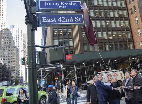 The newly renamed &#x201c;Jimmy Breslin Way&#x201d; is unveiled on 42nd Street on Oct. 17 in honor of the late Daily News columnist. Pulling the cord, from left to right, are Queens City Council Member Daniel Dromm, East Side Member Keith Powers, twin brothers James and Kevin Breslin and East Side state Sen. Brad Hoylman. Photo: New York City Council Photographer John McCarten