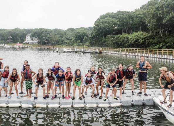 Campers stand poised on a dock at Camp Quinipet, on Shelter Island, NY, run by the New York Conference of the United Methodist Church. Experts say It is important to gauge when and if your child is ready to take the plunge for sleepway camp. Photo: © Camp Quinipet via American Camp Association of NY and NJ