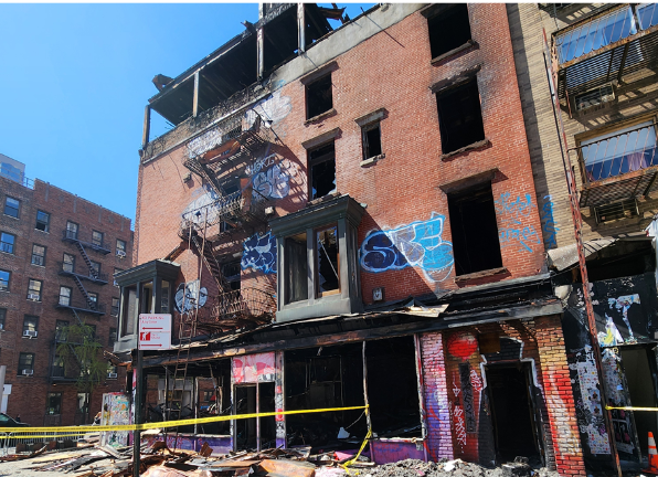 The long vacant building, seen hours after a three alarm blaze was extinguished on April 12, was deemed an imminent safety hazard to the public by the Department of Building, which ordered it to be demolished.