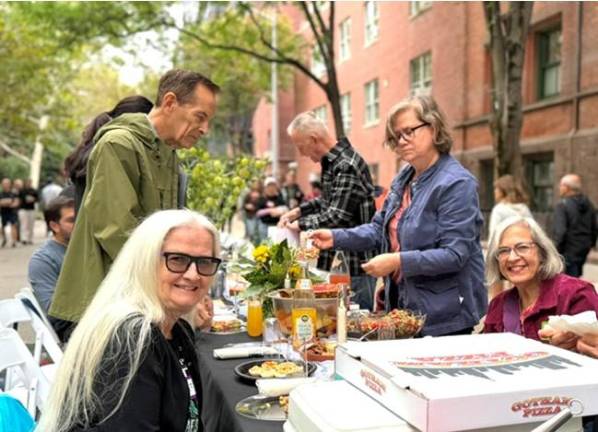 Dishes could be simple or elaborate at the Longest Table in Chelsea. This table opted for pizza-to-go as part of their contribution.