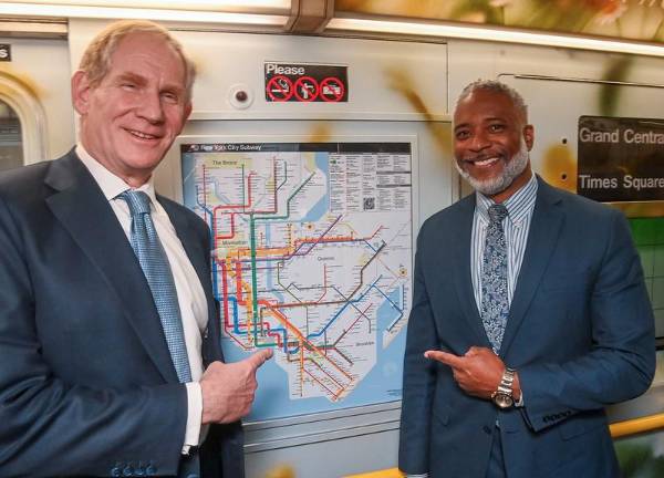 MTA chairman and CEO Janno Leiber (left) and NYC Transit president Demetrius Crichlow unveil the new subway map at the Times Square shuttle stop on April 2. Over the next few weeks, 22,000 paper maps will be distributed on subway cars and in stations.