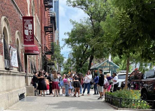 Parents, teachers, and students gather tearfully and say their goodbyes as the last day of classes (ever) for the Guardian Angel School lets out. With the closure of the 10th Ave. institution, the Chelsea area will no longer have any Catholic schools.