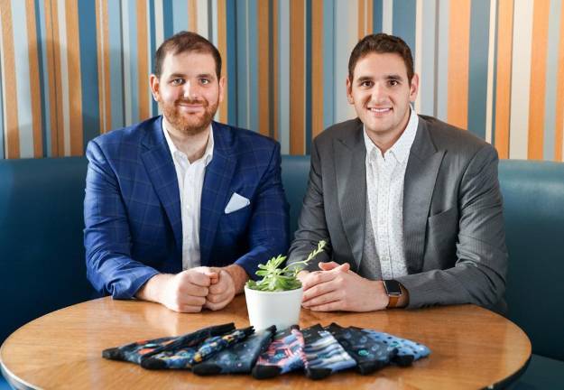 Mike and Dan Friedman with a display of Tall Order Socks. Photo courtesy of the Friedman family