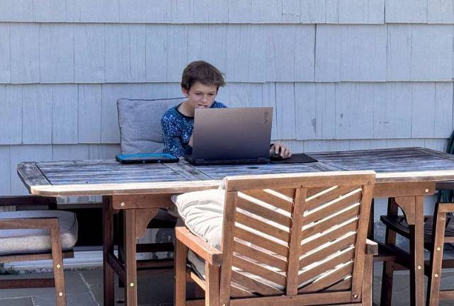 Luca Spinelli is hard at work on a computer.