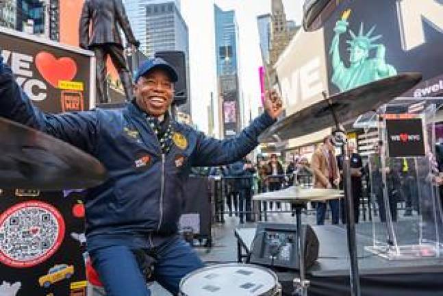 Mayor Adams beats the drums as he drums up enthusiasm for a NYC Marketing drive built around a new I Love NYC logo that he kicked off on March 20s with Kathy Hochul and business leaders in Times Square. Photo: Darren McGee--office of Governor