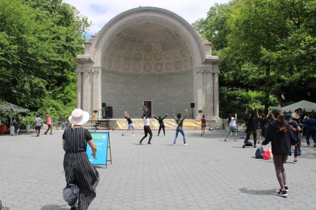 A woman leads a dance session from the Naumburg Bandshell. Photo: Meryl Phair