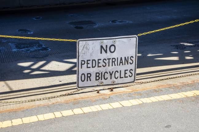 Sign on Queensboro Bridge warning against pedestrians or bicyclists entering the road.