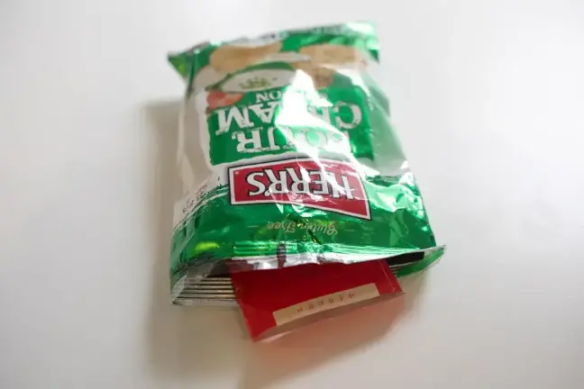 Former City Hall aide Winnie Greco handed THE CITY reporter Katie Honan an opened potato chip bag containing an envelope full of cash after a reelection event for Mayor Eric Adams in Harlem, Aug. 20, 2025.