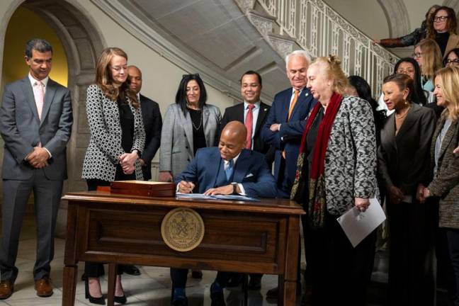 Mayor Eric Adams signed into law several bills concerning lithium ion batteries while FDNY Commisioner Laura Kavanagh (to left of Adams in photo) and other civic leaders look on. <b>Photo: Ed Reed/Office of the Mayor.</b>