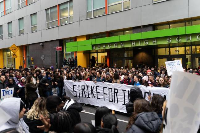 Hundreds of Beacon students stood behind and around a banner that read STRIKE FOR INTEGRATION in front of the school's entrance.