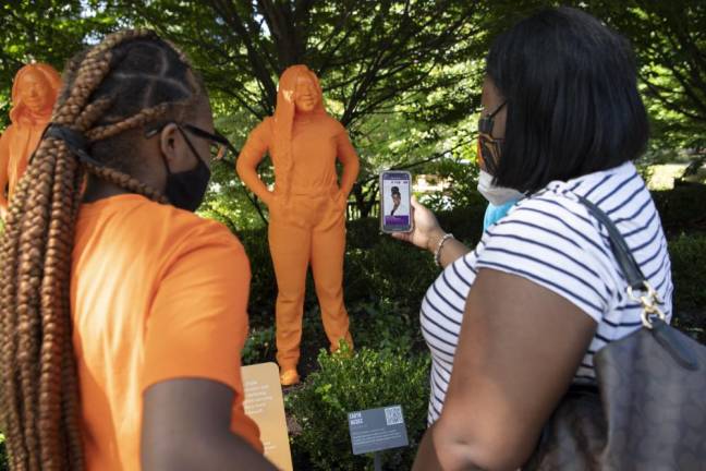 Visitors looking at statue of herpetologist Earyn McGee. Photo: Julie Larsen Maher