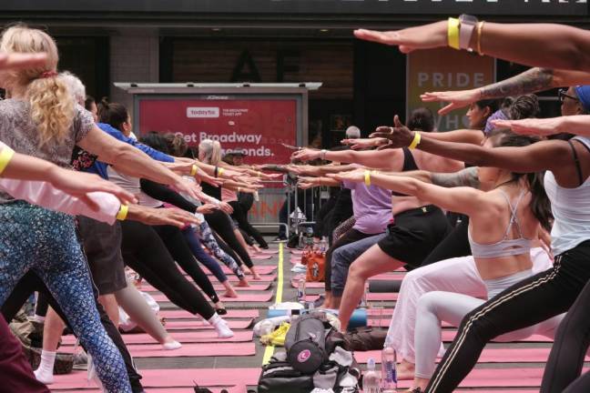 Streteching it out in the middle of Times Square at the annual summer solstice yoga event staged by the Times Square Alliance. Photo: Beau Matic