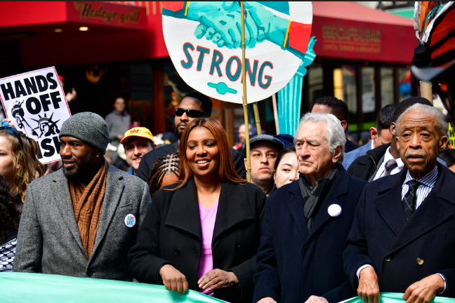 Marching behind a light green banner that read “We Protest Our Democracy” were (from left) public advocate Jamaane Williams, NYS Attorney General Letitia James, actor Robert De Niro and the Rev. Al Sharpton.
