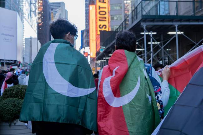 Ahmad (right) and his son stand in solidarity with the people of Palestine.