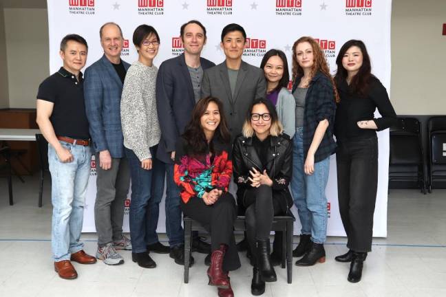 The cast of Golden Shield stand and pose behind director May Adrales and playwright Anchuli Felicia King. Photo: Lia Chang