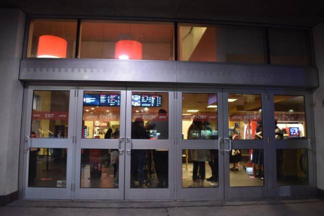 People fill the lobby inside the AMC Village 7 Theaters on the evening of Friday, March 12. Photo: Leah Foreman