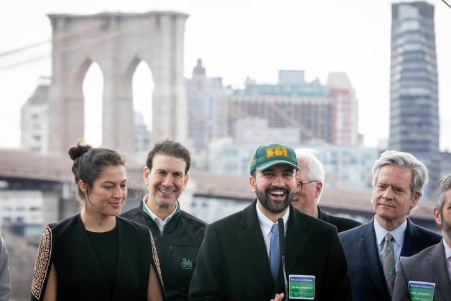 Mayor Mamdani in DOT cap at Pier 17 announcing Brooklyn Bridge access glow up, March 27.
