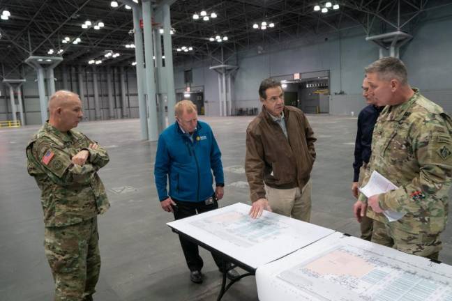 Gov. Andrew Cuomo meets with military officials at the Jacob K. Javits Convention Center, where a temporary FEMA hospital is being set up.