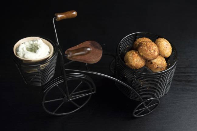 Corn paddu is served on a miniature bicycle. Photo: Evan Sung