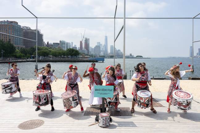 A drum group performs along the Hudson River during West Side Fest.