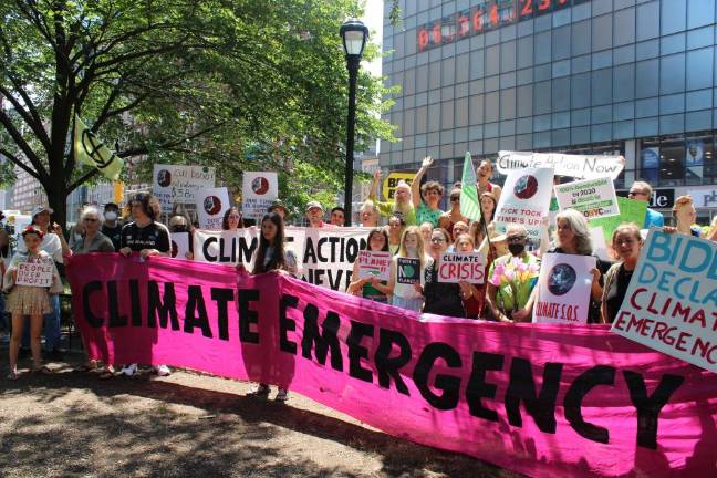 A crowd gathers in front of the Climate Clock on the first “Climate Emergency Day.” Photo: Meryl Phair