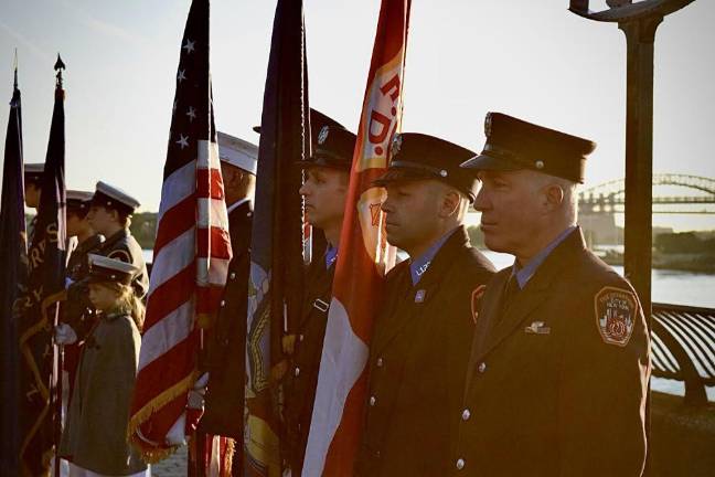 At sunrise commemoration on Saturday, the presentation of the colors, presented by David Menegon and the Knickerbocker Greys. Photo: Emily Higginbotham