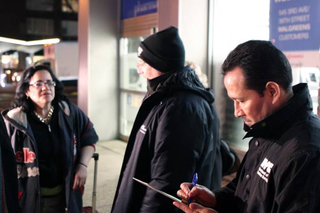 Department of Social Services Commissioner Steven Banks and Manhattan Outreach Consortium Director Mario Arias engage a woman living on the street. Photo courtesy of the Department of Homeless Services